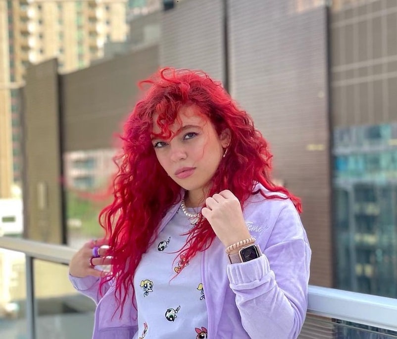 red curly hair with curtain bangs