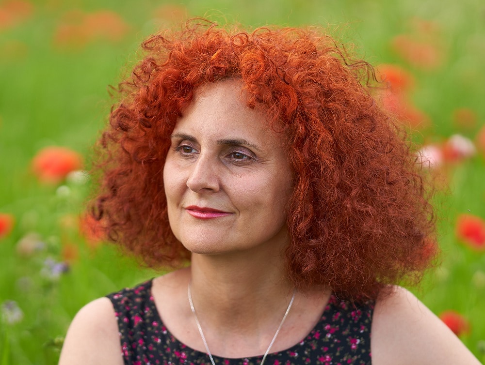 red curly hairstyle for women over 50