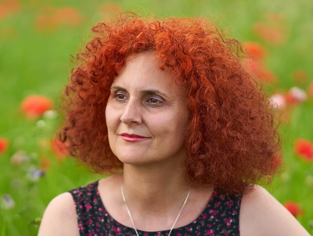 red curly hairstyle for women over 50