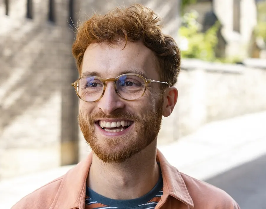 red-haired british man wearing glasses