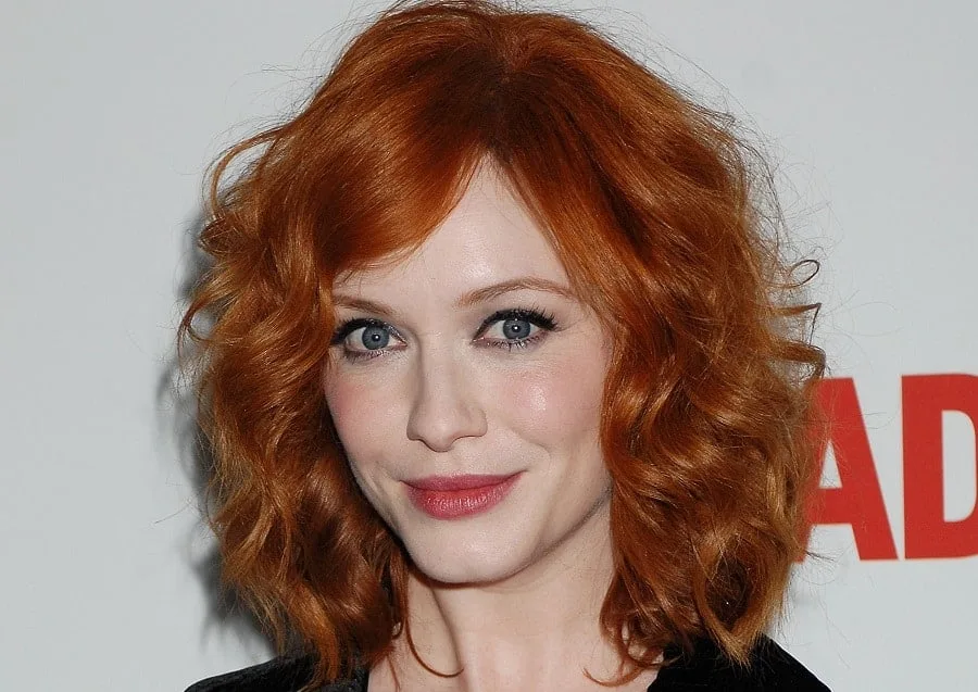 redhead celebrity Christina Hendricks with curly bob and side bangs