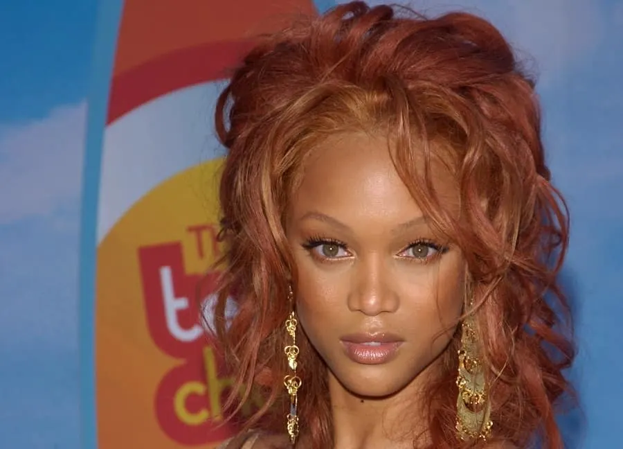 redhead celebrity with messy curly updo- Tyra Banks