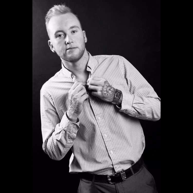 Blonde man with a rounded top haircut styled to flatter hair loss at the temples