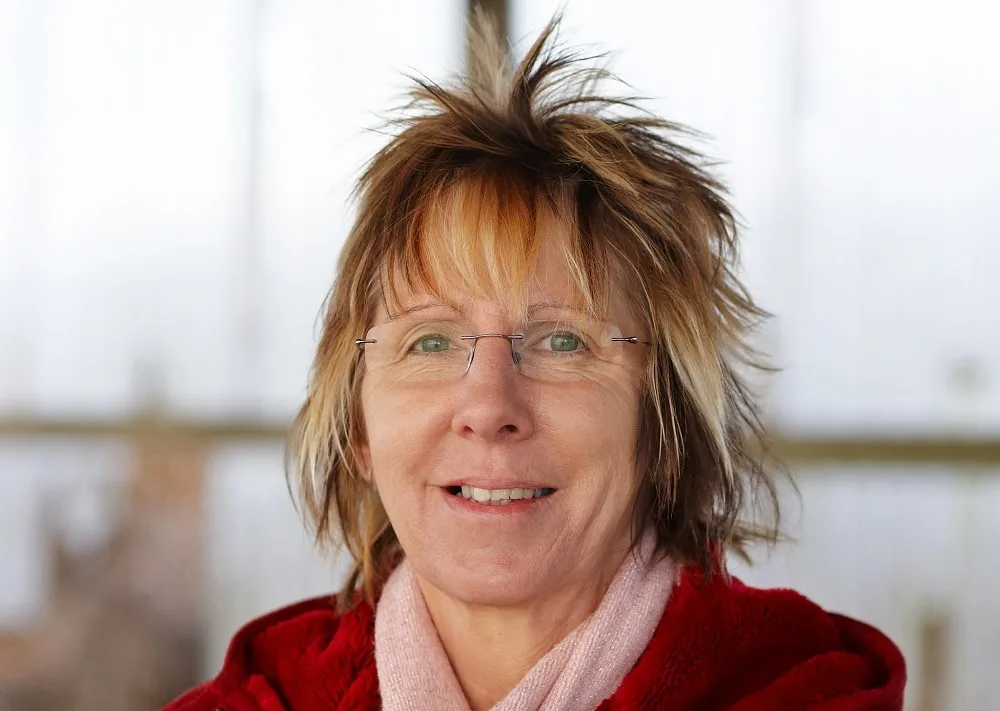 shaggy layered hairstyle for over 50 with glasses