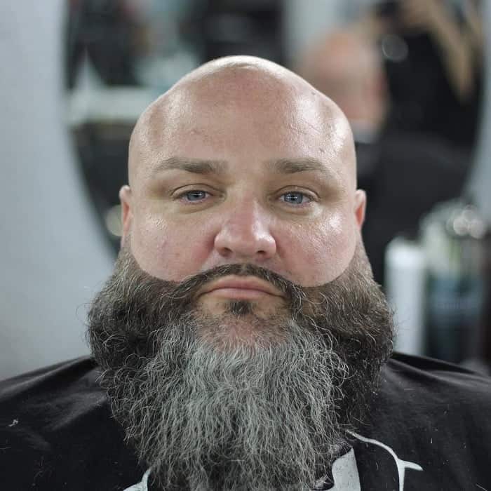 shaved head with wavy beard 