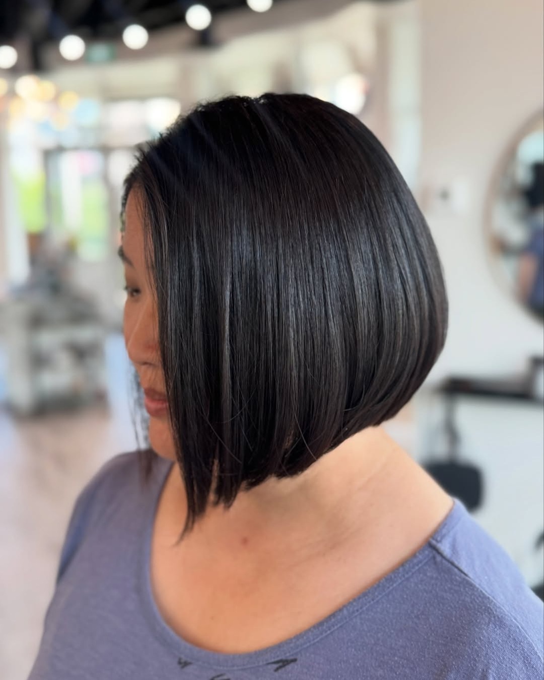 sleek dark brown short angled bob haircut for round faces