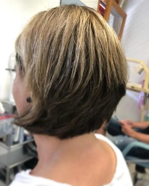 layered short brown bob with blonde highlights
