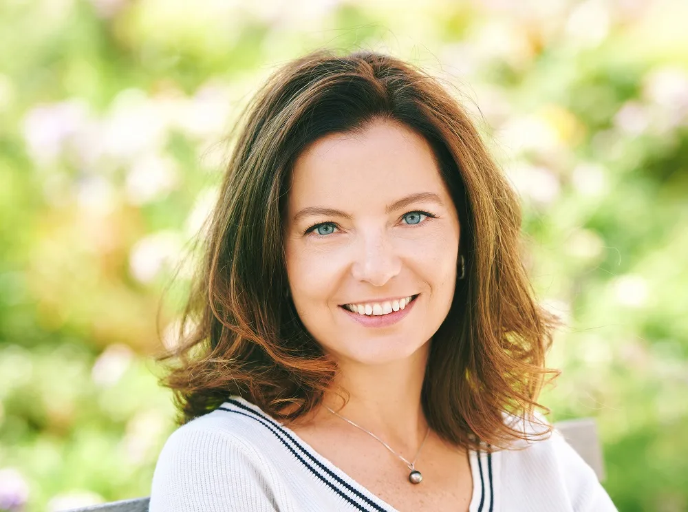 Short brown hairstyle over 50 with a round face