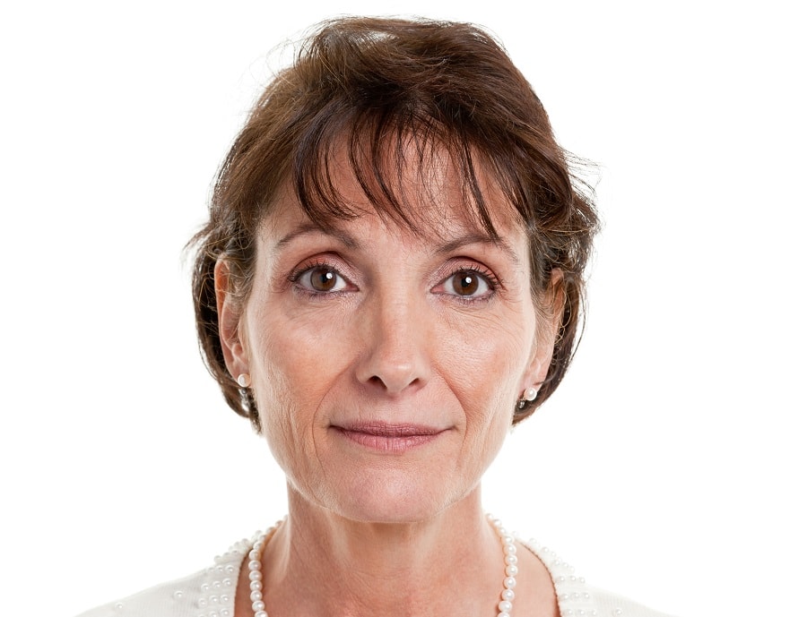 short brunette hairstyle with bangs for women over 50