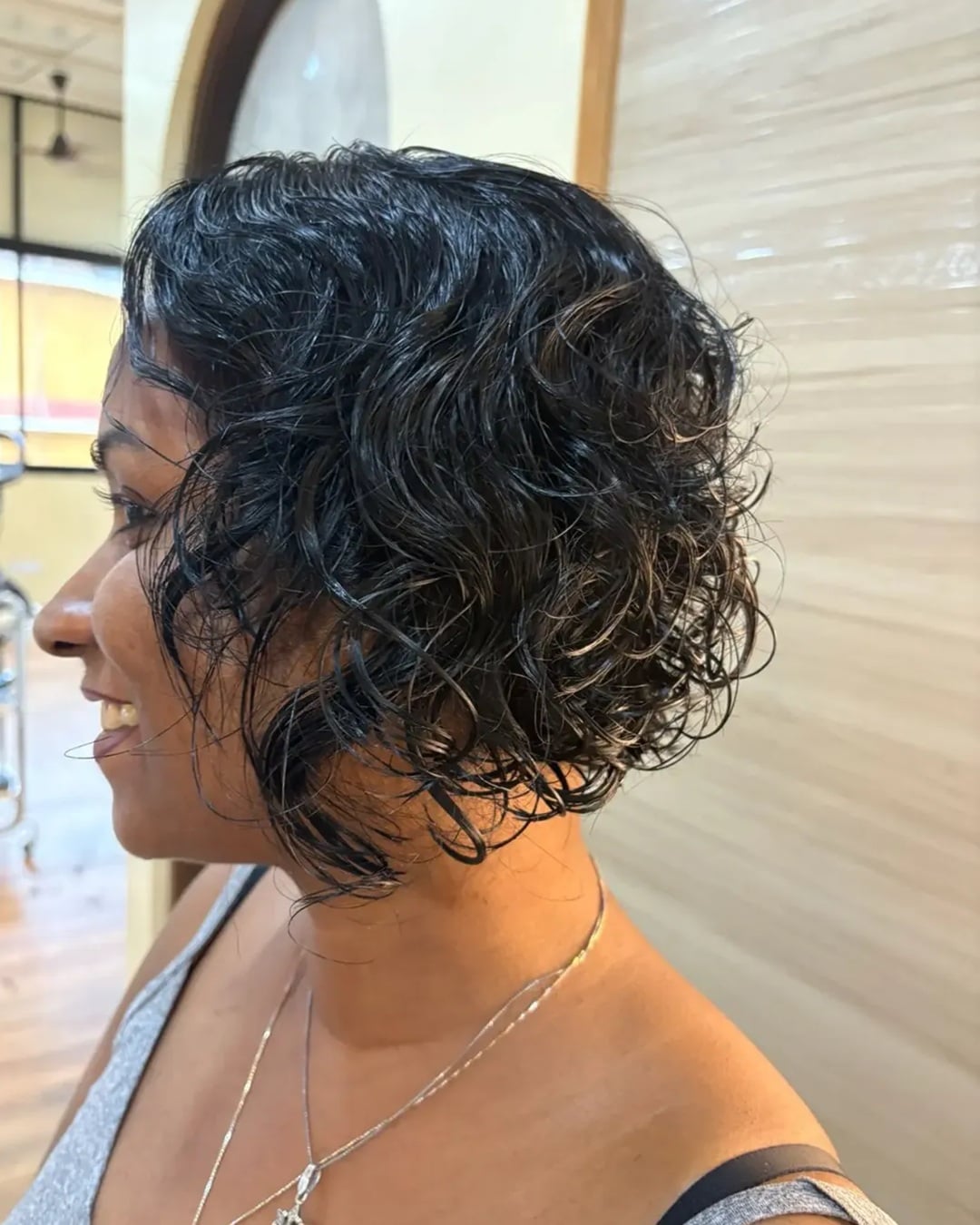 Indian woman with short curly bob