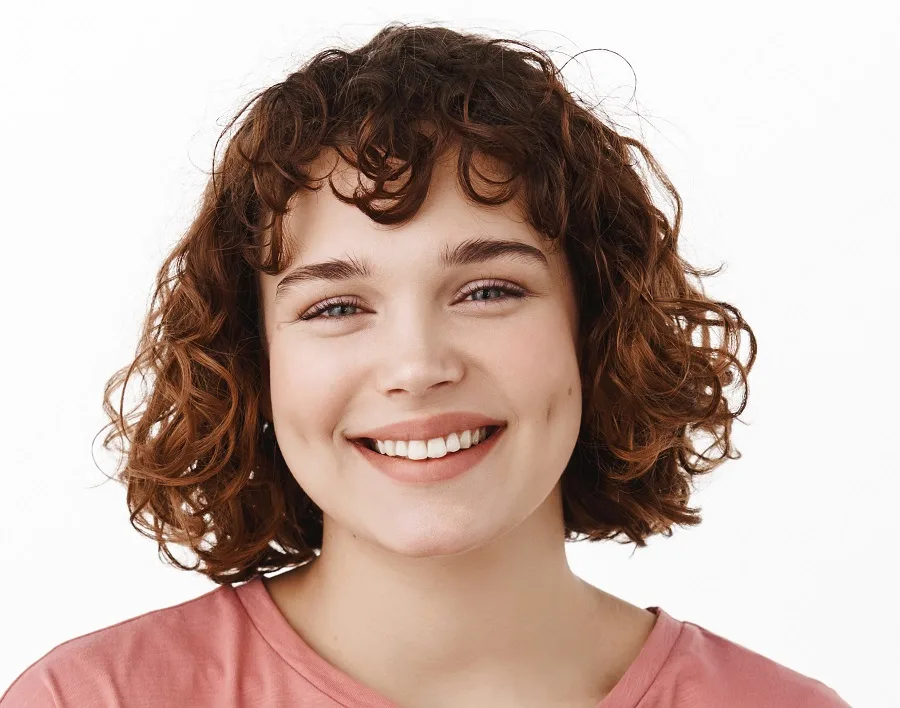 Short curly bob with bangs for women with round faces