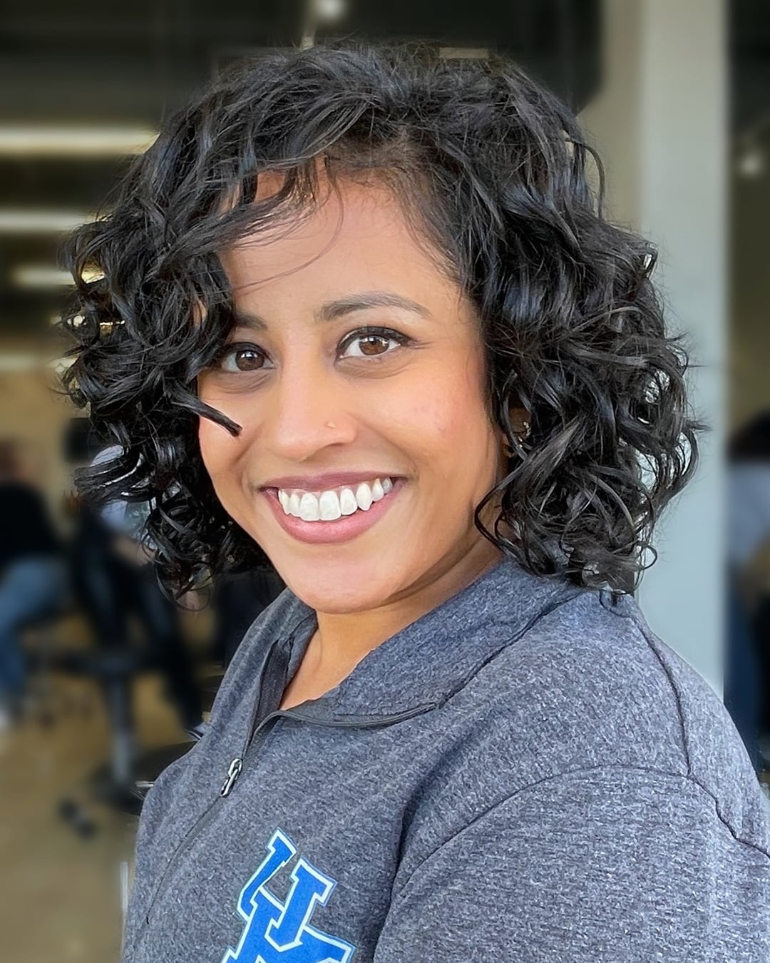 short curly bob with side swept fringe