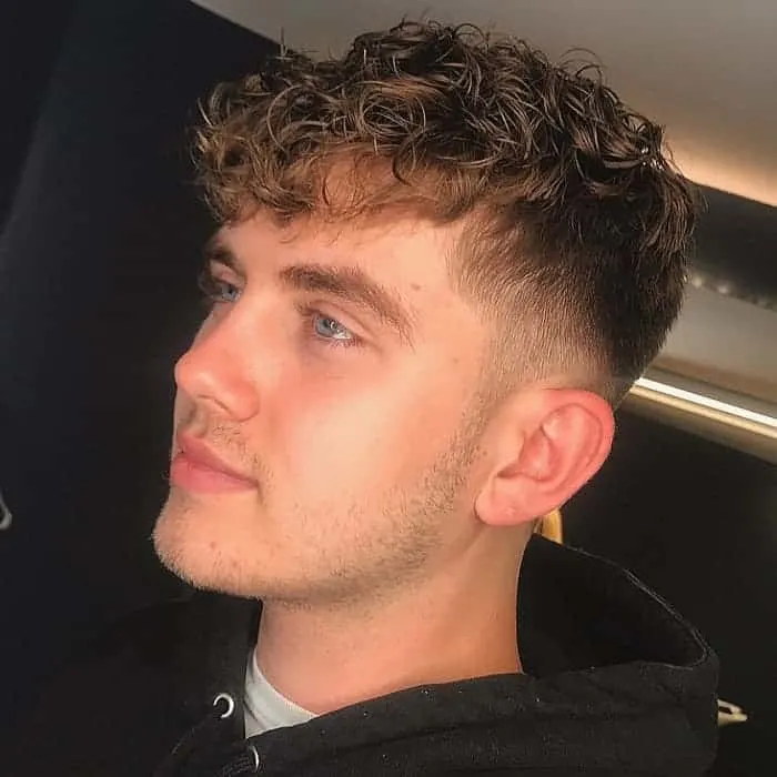 guy with short curly bangs