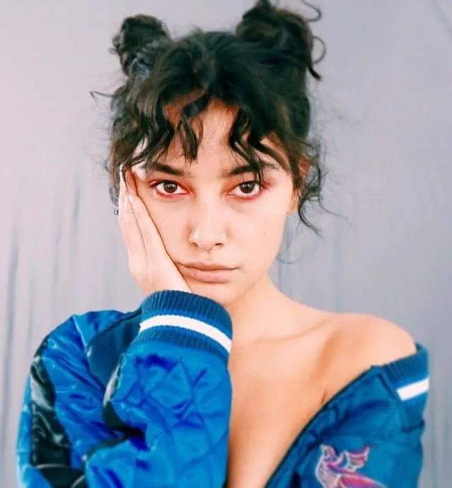 curly space bun with bangs