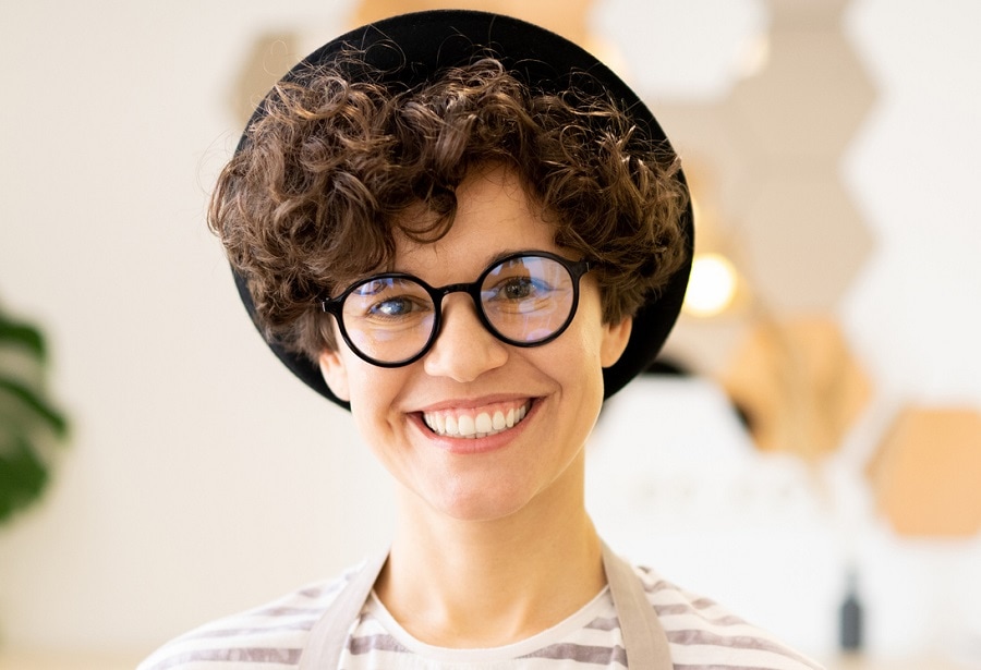 short curly hairstyle with hat at work