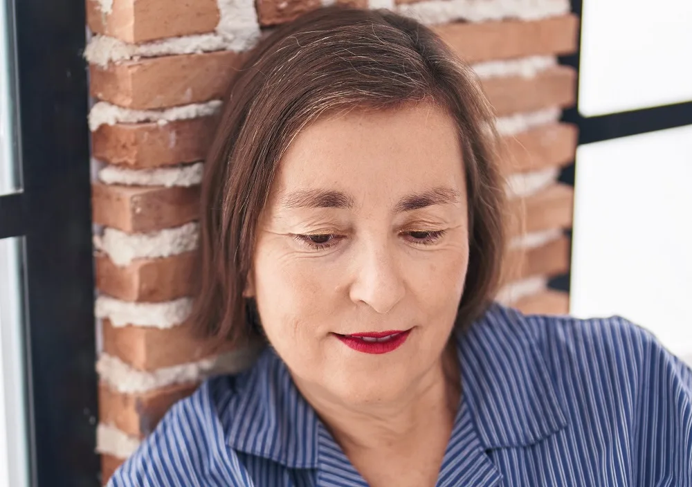 Delicate short hairstyle over 50 with a round face