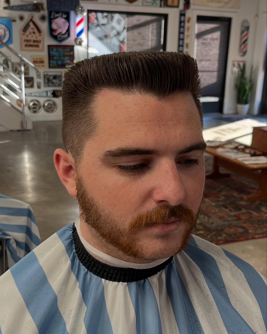 Classic short flat top haircut with a clean box shape and tapered sides