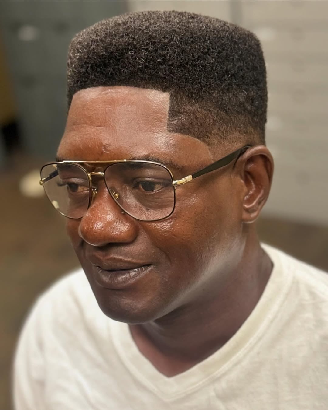 black guy with short high top fade haircut with clean edge up