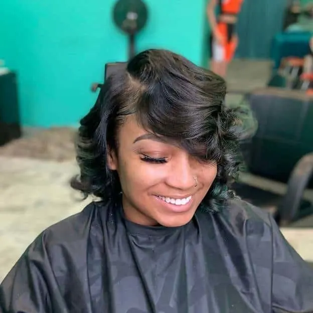 short layered curly hair with side swept bangs 