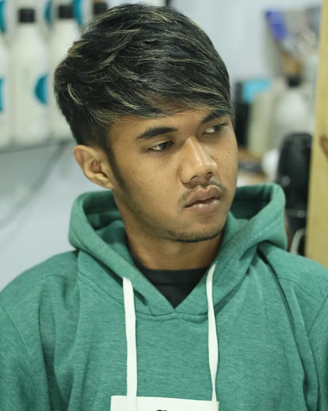 layered short haircut with long side swept bangs for men with round face