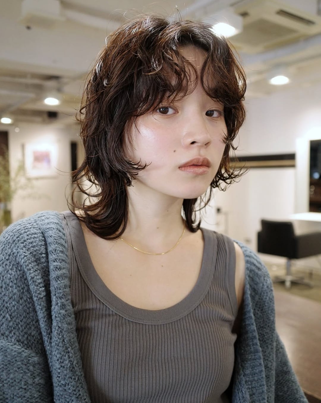 Short dark brown permed shag haircut for thin hair