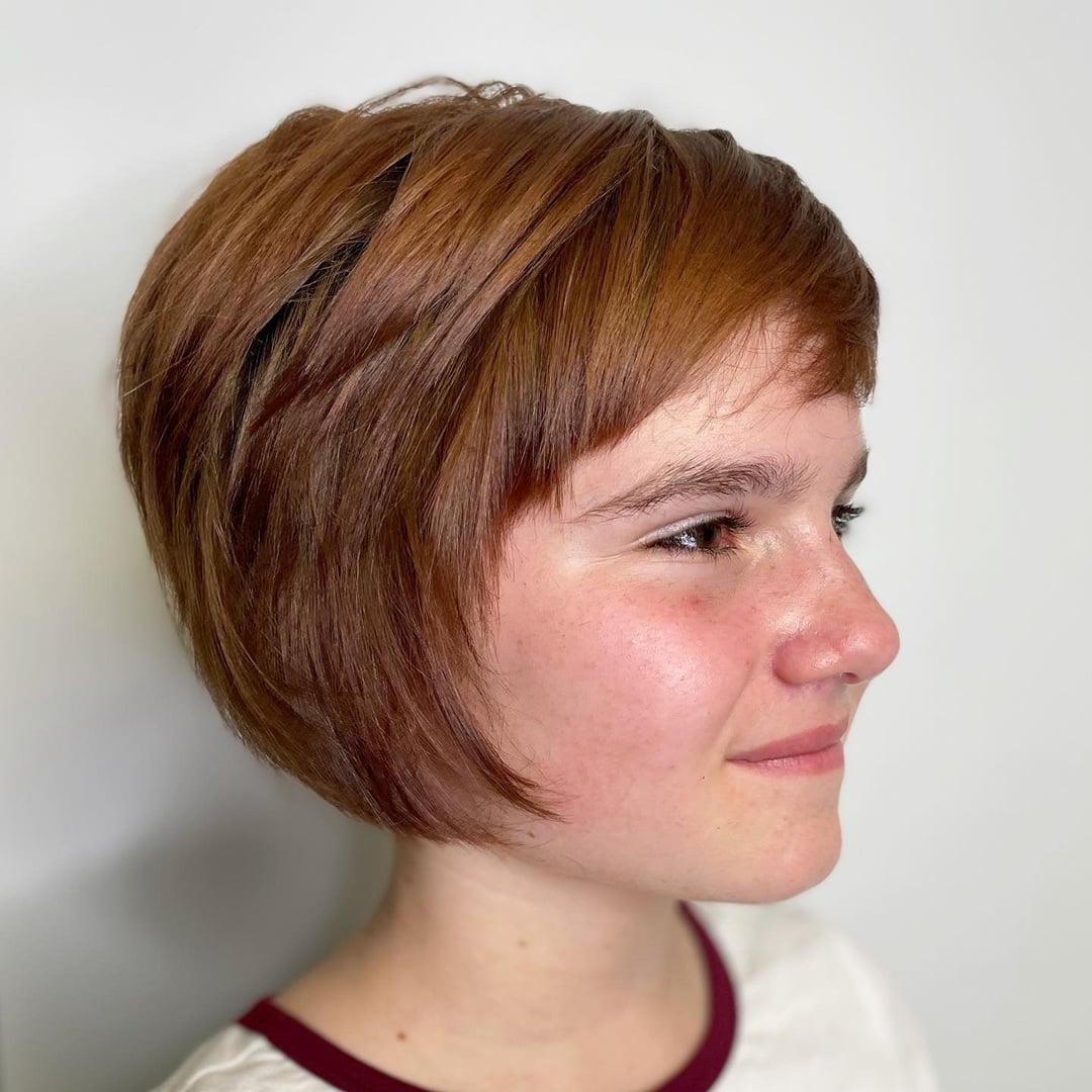 little girl with short red pixie bob and short straight bangs