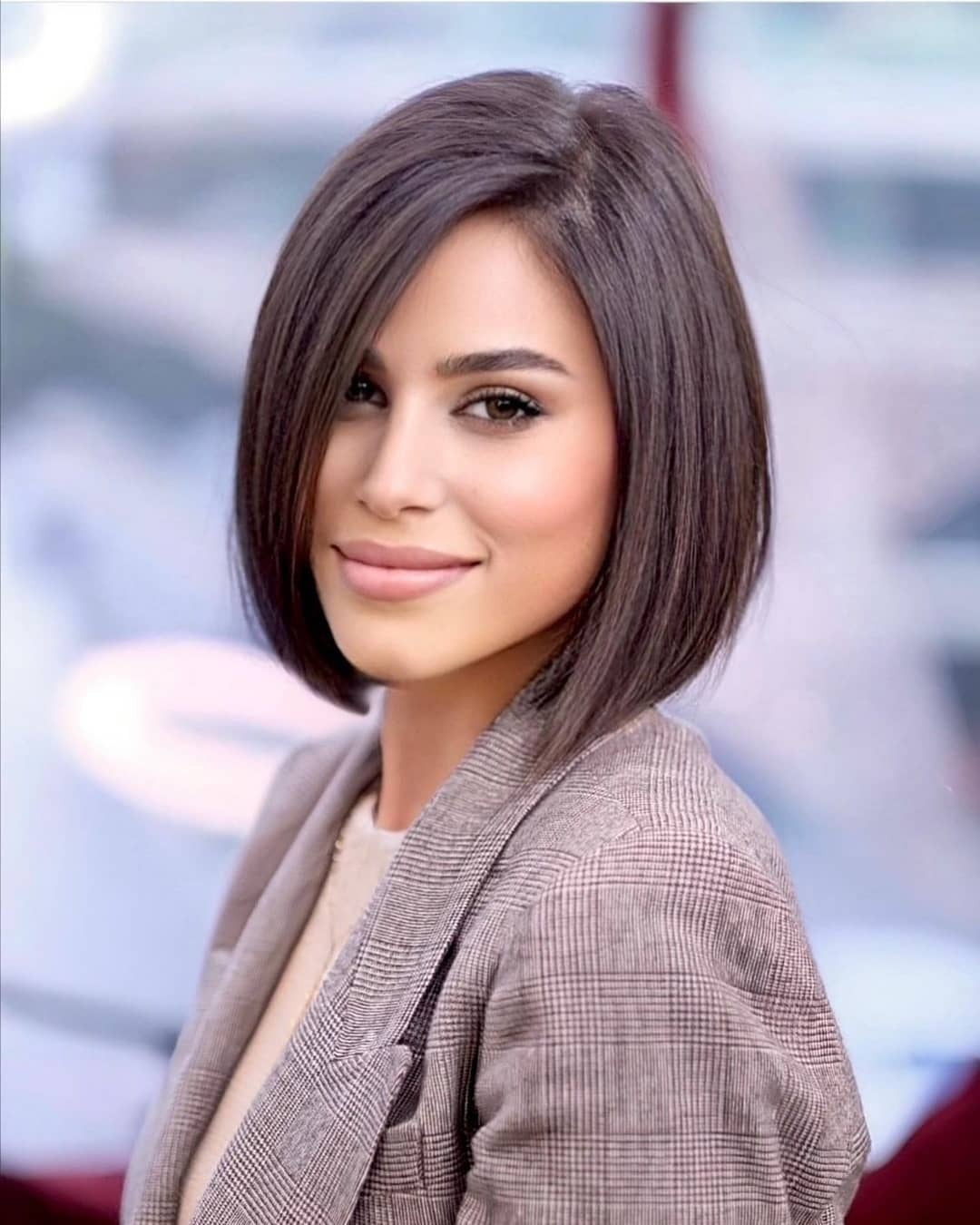 dark brown short rounded stacked bob haircut