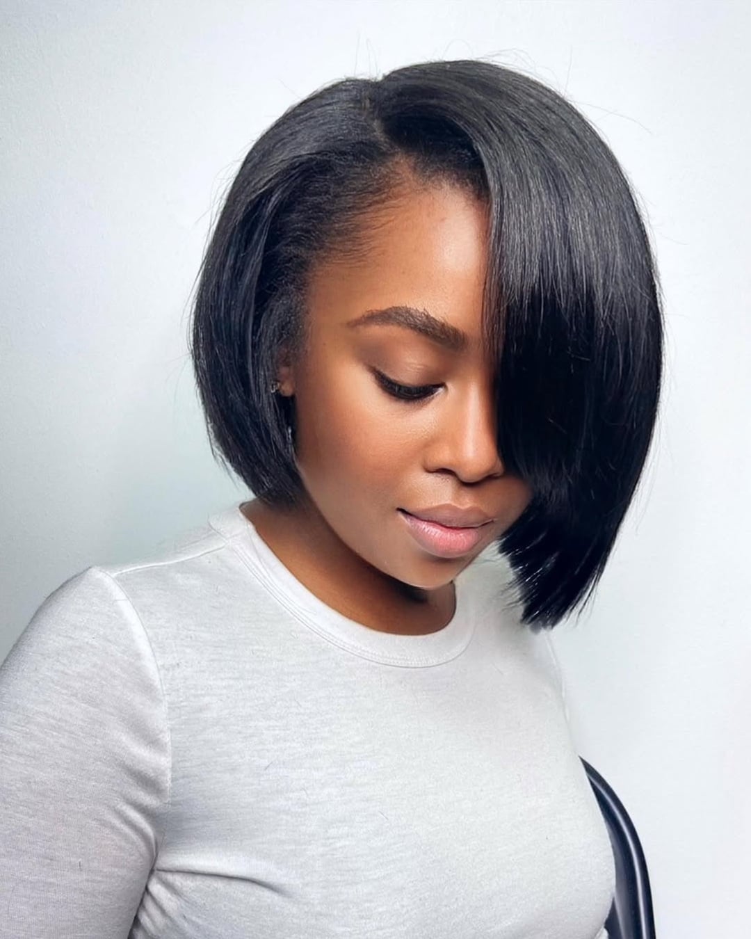 sleek side-parted short black sew-in bob haircut