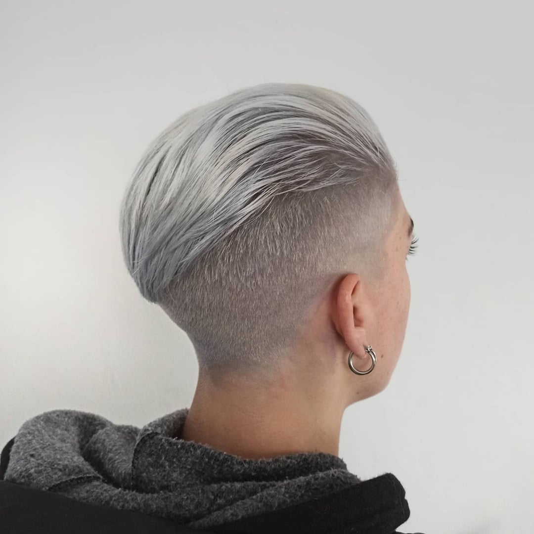 short silver hair with a smooth slicked-back top and clean tapered undercut