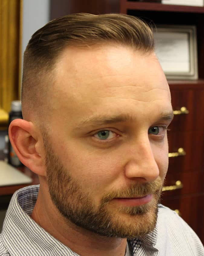 Neat short slick undercut brushed back to complement a high hairline