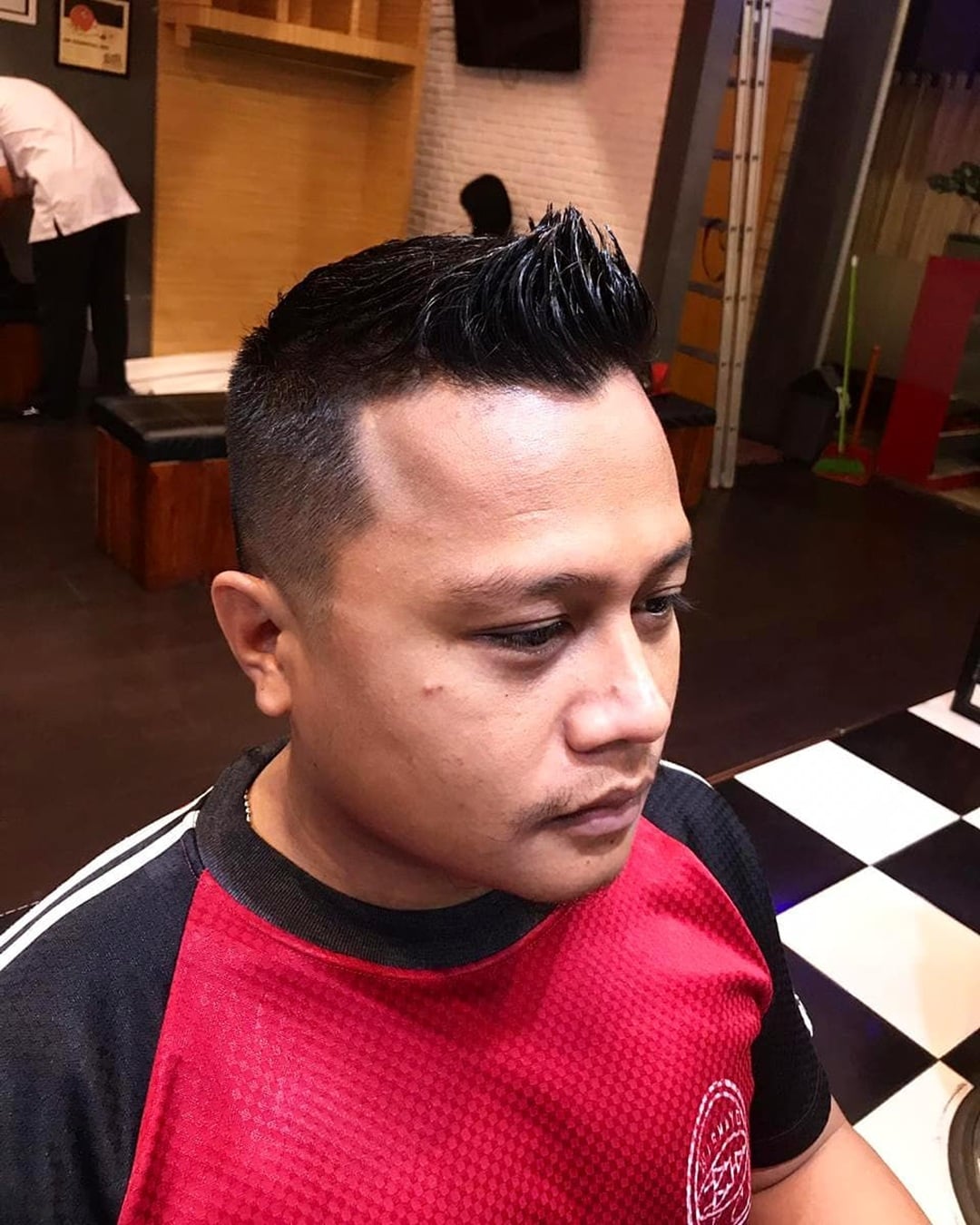 short spiky faux hawk haircut with mid fade