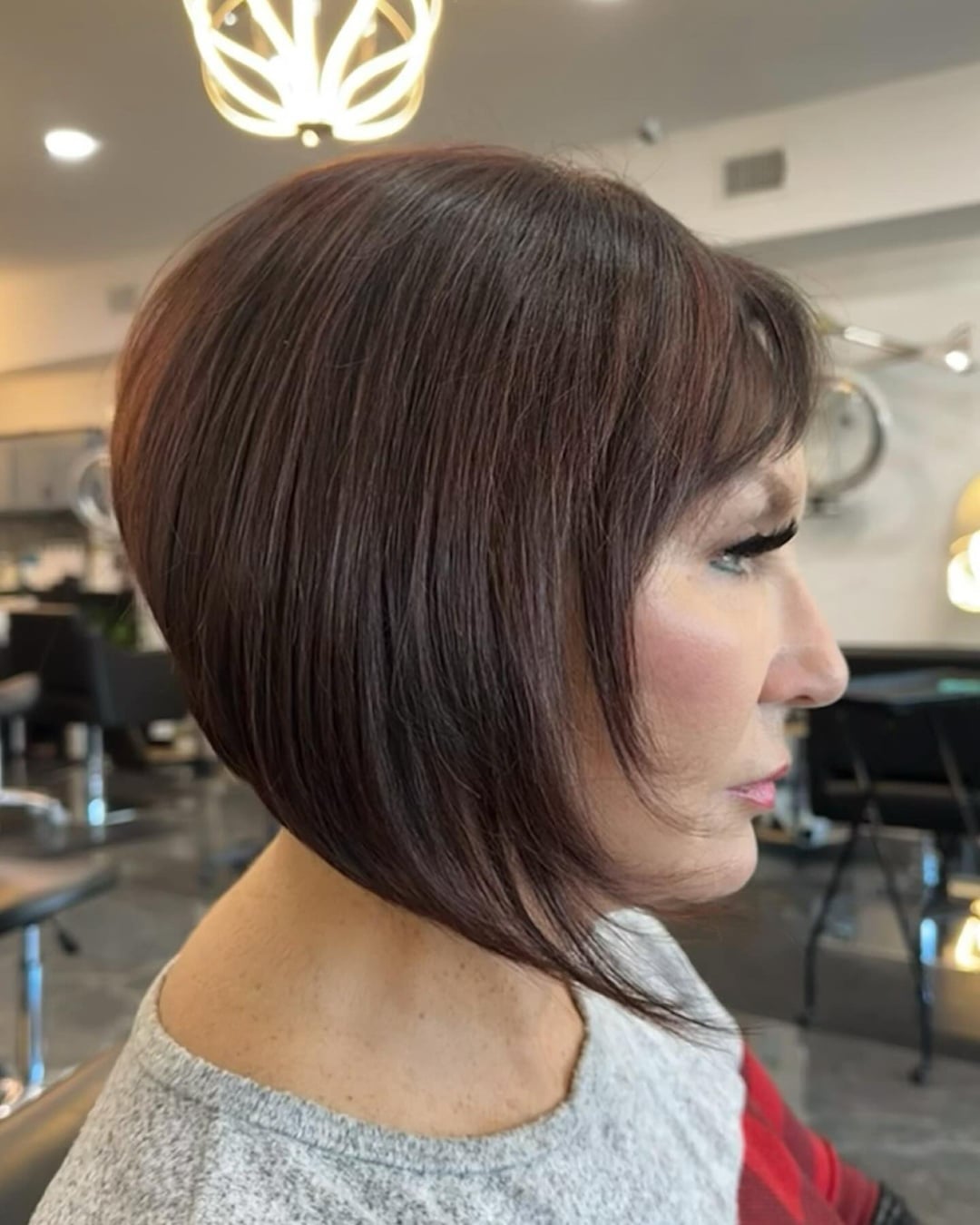 dark brown short stacked bob with side swept bangs
