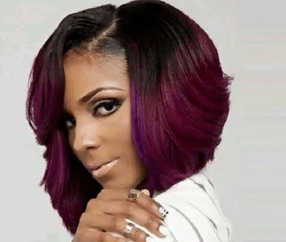 short stacked bob with feathered side-swept layers and a vibrant plum purple ombre