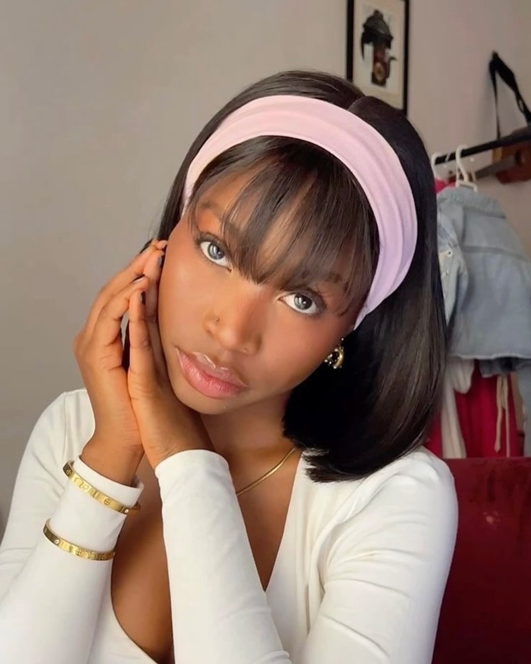 teen black girl with sleek bob, straight bangs, and a pink headband