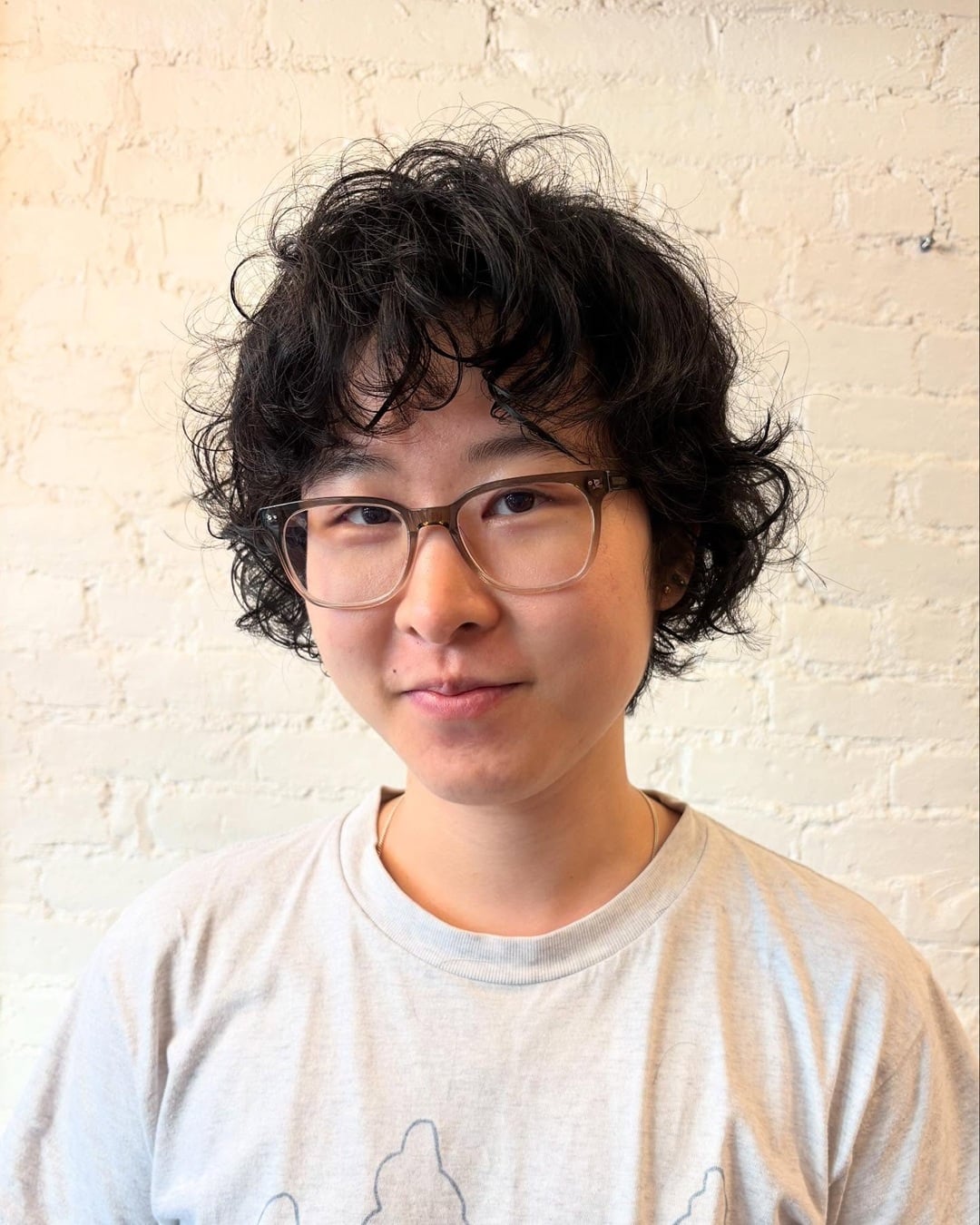 Short wavy Asian pixie cut with messy bangs