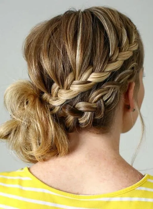 women with double braided side messy bun