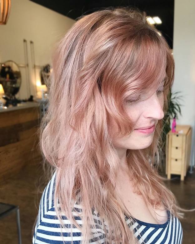 side swept bangs with rose gold hair