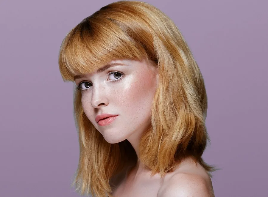 single process warm blonde hair with bangs