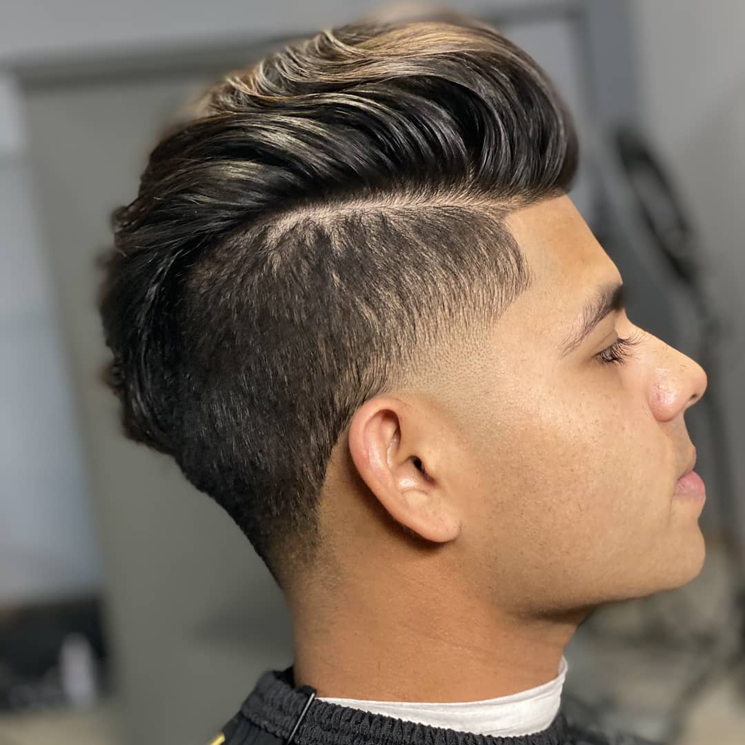 Indian man with voluminous side-swept quiff and hard part line