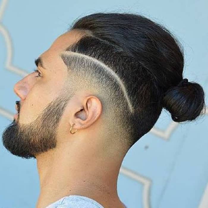 A guy with a smooth back bun