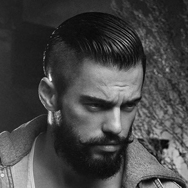 Slicked back haircut and shaved sides emphasizing a widow's peak