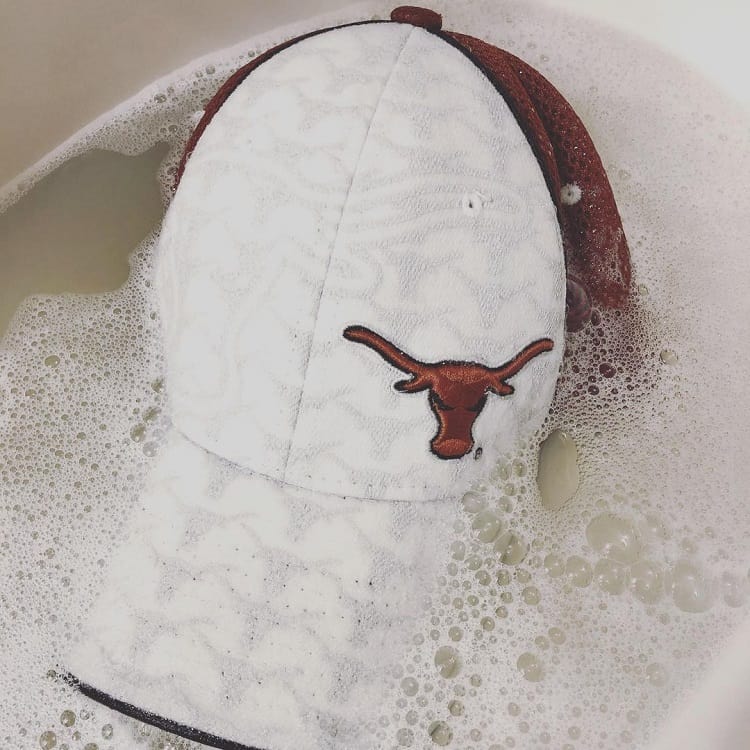 soak fitted hat in hot water to shrink