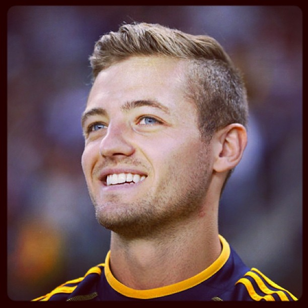 Soccer player Robbie Rogers with a short side-parted haircut and subtle highlights