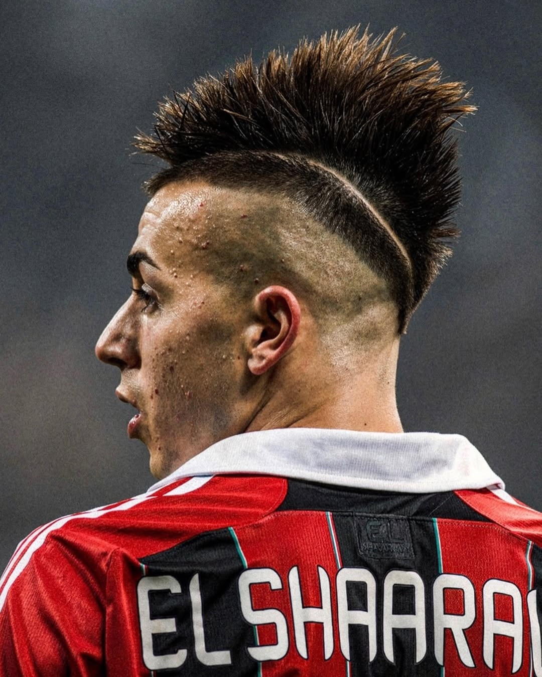 Soccer player with spiky mohawk haircut and shaved trameline