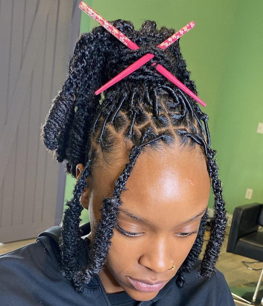 soft locs hairstyle with hair stick