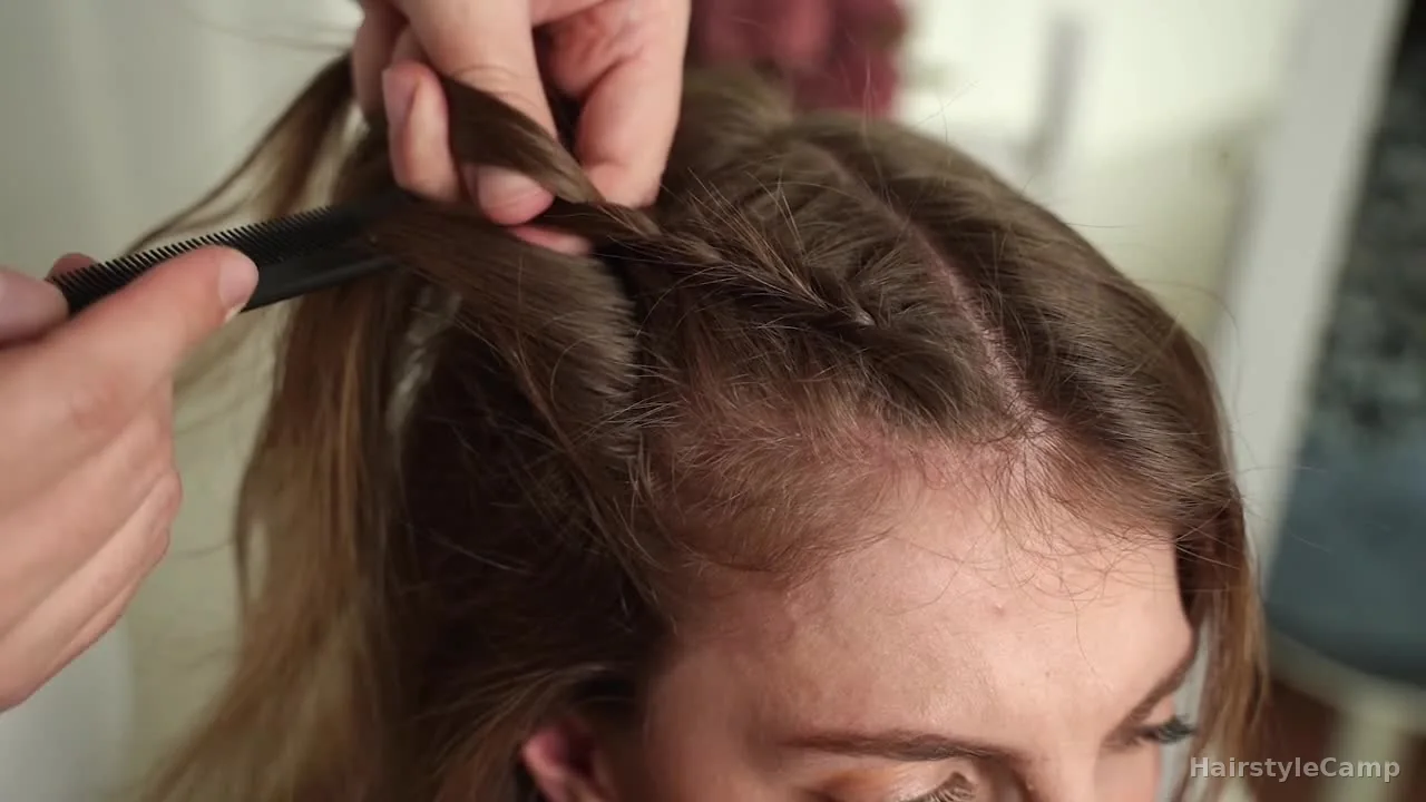 Outer section being combed flat before it is added into the braid on the side of the head.