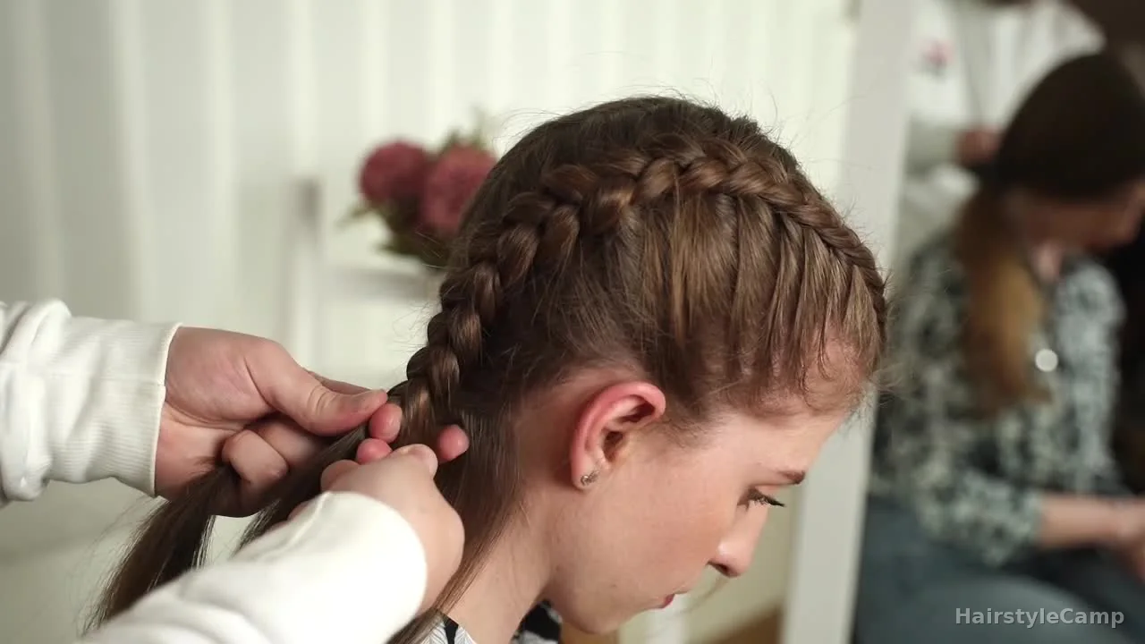 Braid reaching the nape and continuing into a regular three-strand tail.