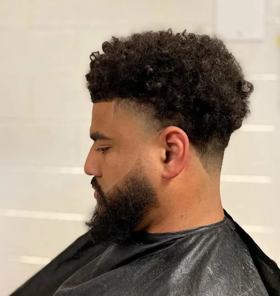 curly taper fade with beard