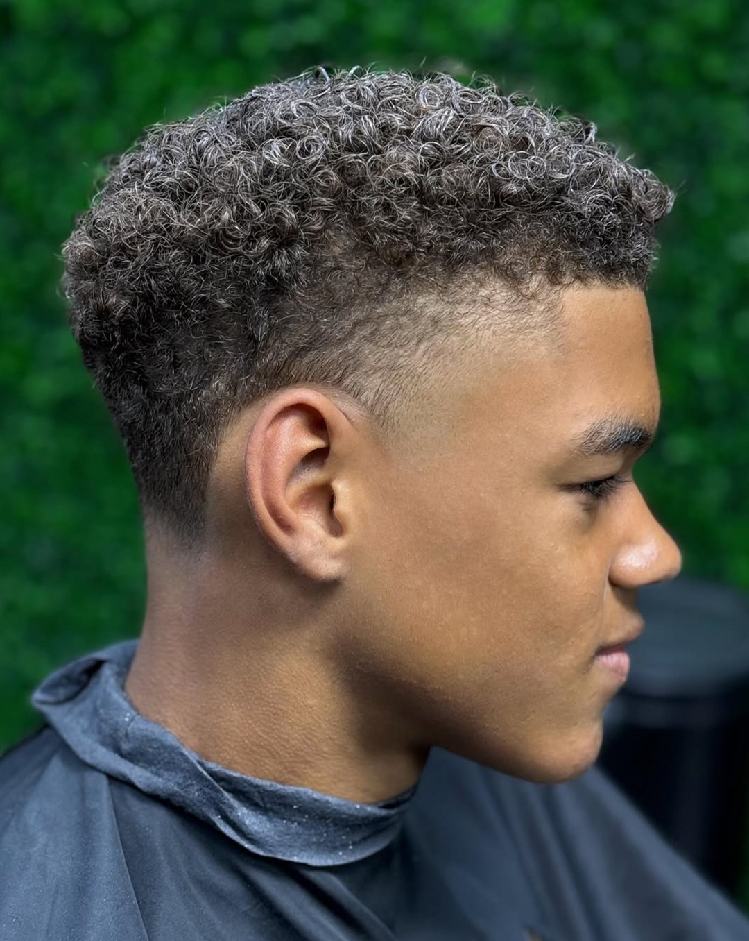 Taper fade haircut with short tight curls