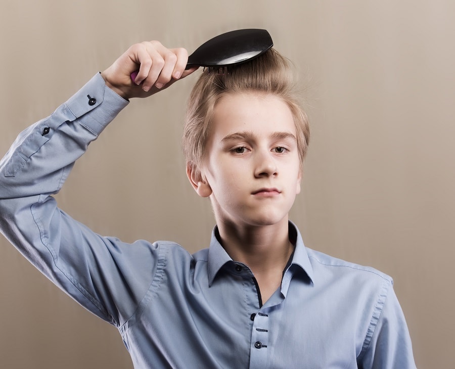 teen boy combing scalp